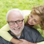 Happy older man with beautiful woman smiling outdoors