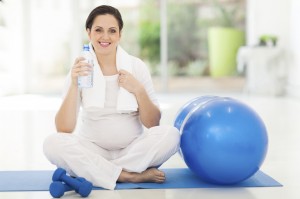 pregnant woman holding bottle of water