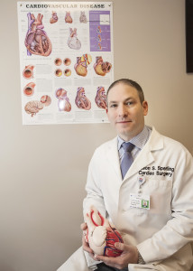 Dr. Jason Sperling uses a model of the heart to explain conditions his new program is targeting.
